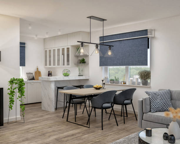 Modern dining area featuring a stylish table, gray chairs, and a well-appointed kitchen with natural light.