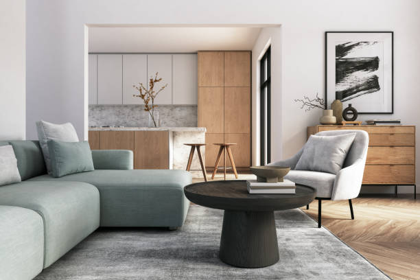 Modern living room with a light-colored sofa, black coffee table, and a stylish kitchen in the background.
