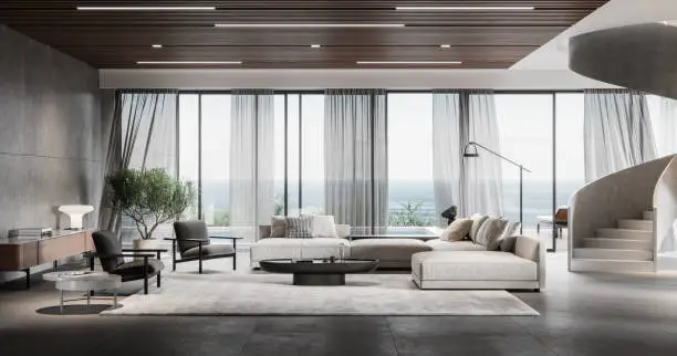 Stylish modern living room with large windows showcasing a scenic view, featuring sleek furniture and an elegant staircase.