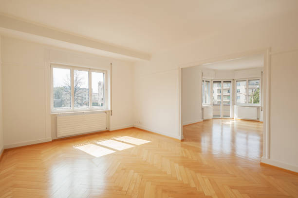 Bright, spacious living area with hardwood flooring and large windows.